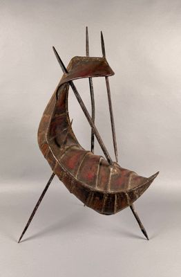 sculpture of a boat made of wood and metal on a white surface