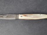 a picture of a knife that is on a table