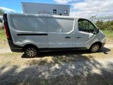 the van is parked on the side of the road in front of a building