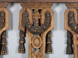 two wooden clocks hanging on the wall next to each other