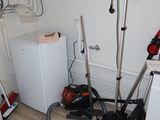 an image of a room with a washing machine and a vacuum