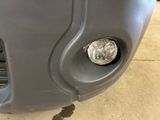 a close up of a car ' s front bumper with a light on