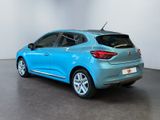 the rear end of a blue car in a white room