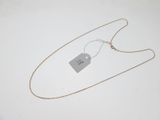 a close up of a silver necklace with a tag on it