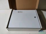 a white refrigerator sitting inside of a box on the floor