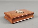 an old wooden box with a silver plate on top