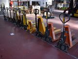 many forklifts lined up in a row in a warehouse