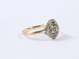 a close up of a gold and diamond ring on a white background
