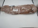 a piece of brown fur wrapped in plastic on a table