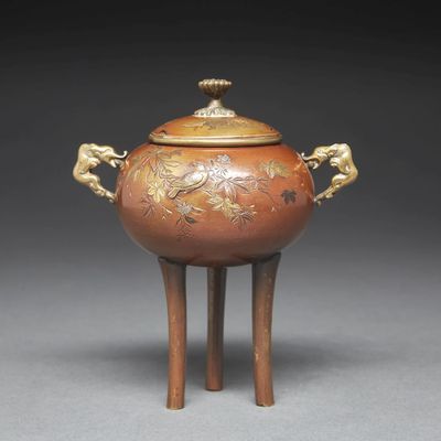 an image of a brown and gold vase with two lions on it