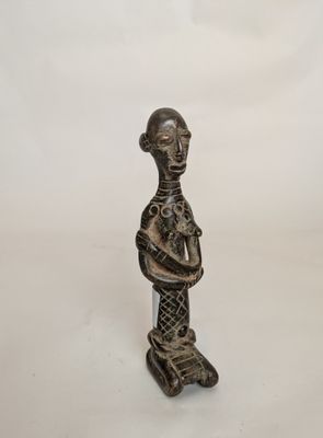 an image of a statue of a woman holding a baby