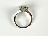 a diamond ring on a white surface with a white background