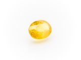a yellow sapphire stone on a white background