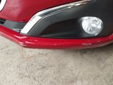 a close up of a red car with a black bumper