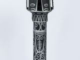 an image of a black and white sculpture of a bird on a pole