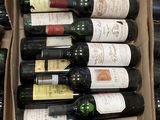 bottles of wine are in a cardboard box on a table
