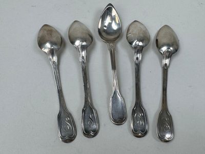 six spoons are lined up in a row on a white surface