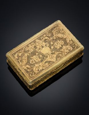 a gold - plated cigarette case with a design of flowers and leaves
