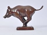 bronze sculpture of a running boar on a wooden base