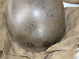 a helmet that is sitting on a cloth on a table