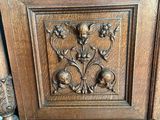 an old wooden cabinet with carvings on the front of it