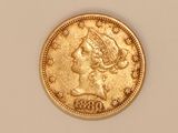 a close up of a gold coin with a woman ' s head on it