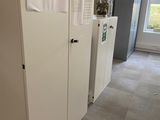 a room that has a bunch of white cabinets in it