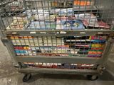 a metal cart filled with books and magazines on the floor