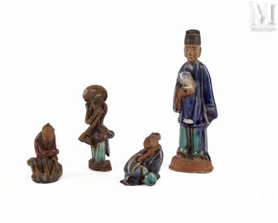 three figurines of a man and a woman and a child