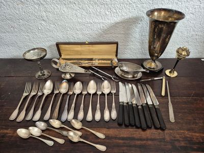 a lot of silver spoons and silverware on a table