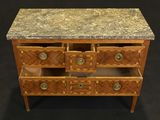 a marble top chest of drawers on a black background