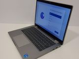 the laptop is open on a white surface with a blue screen
