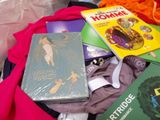 a pile of books that are sitting on a bed