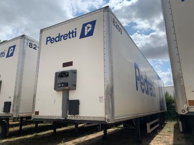 trois semi-remorques garées en file indienne sur le bord de la route