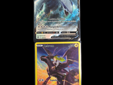 two pokemon cards are sitting next to each other on a black background