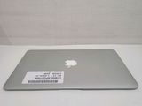 a silver apple laptop sitting on a white table