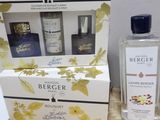 two bottles of cologne and a box of cologne sitting on a table