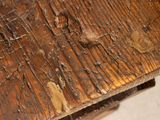 a close up of a wooden table with peeling paint on it