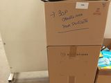 several boxes stacked on top of each other in a room