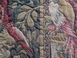 a close up of a tapestry with birds and flowers on it