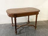 a small table with a wooden top on a cement floor