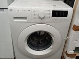 a washing machine that is sitting in the corner of a room
