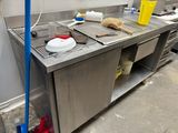 a kitchen with a sink and a broom in it