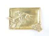 gold plate with a dog and a man on a leash