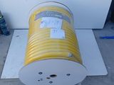 a yellow hose sitting on the ground next to a white box