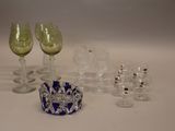 many glasses and a bowl sitting on a table