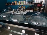 three bowls of food on display in a glass case