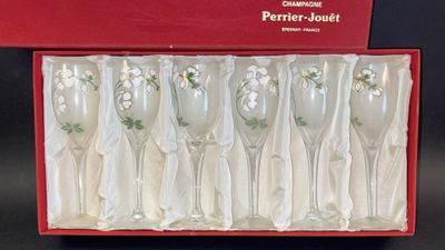 six wine glasses in a red box on a table