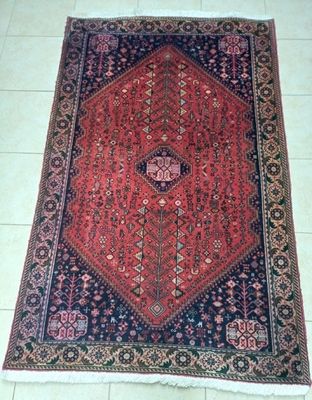an oriental rug on a tile floor with a white floor