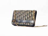 a brown and black purse sitting on top of a white surface